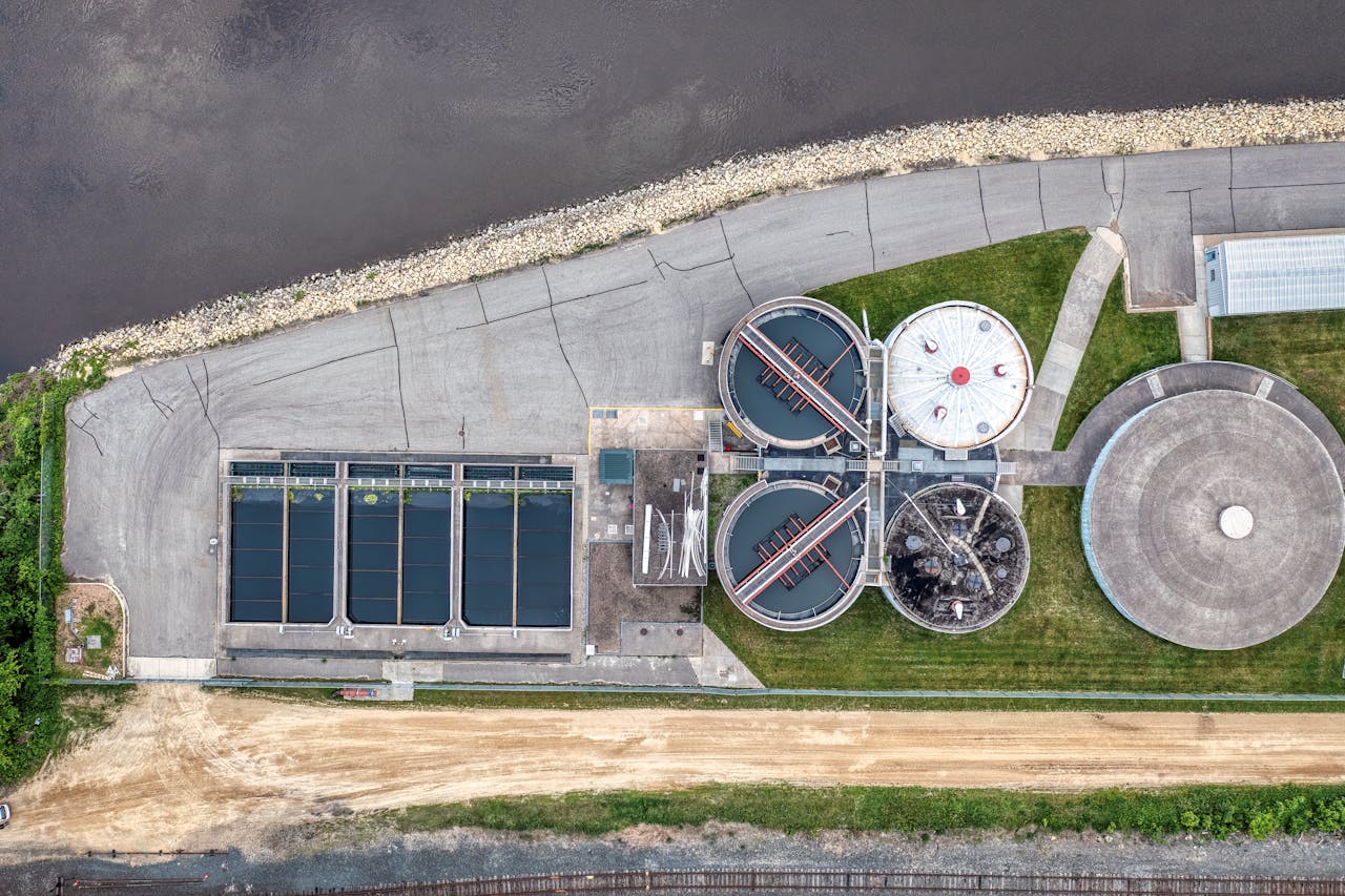 why-choose-us Top-down aerial view of a water treatment plant in Red Wing, MN near a river.