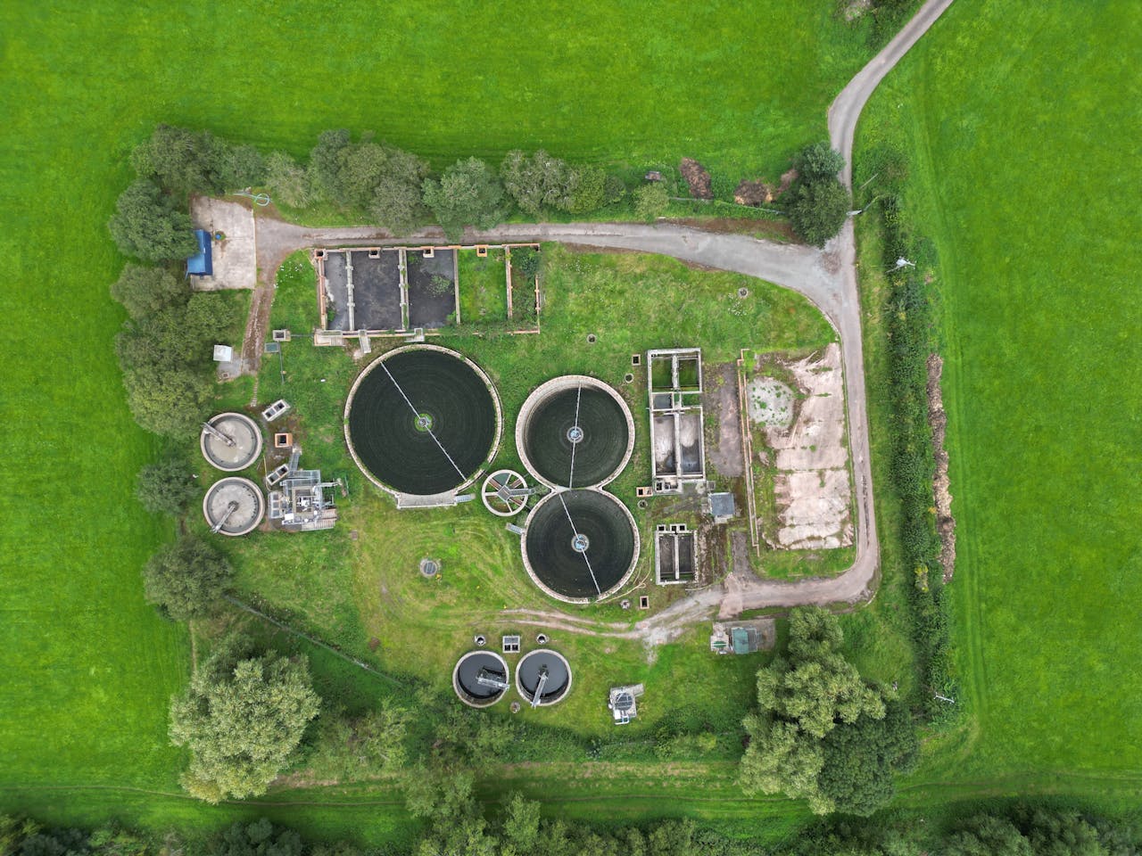 Aerial view of a wastewater treatment plant surrounded by lush greenery in Crickhowell, Wales.